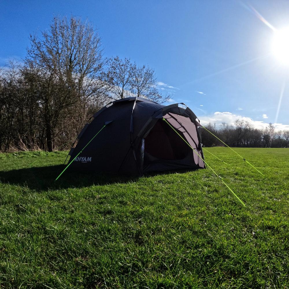 Photograph of LocTek Igloo MK3 Fast Pitch Tent - 3 Man Tent Khyam on grassy campsite with sunny blue sky.